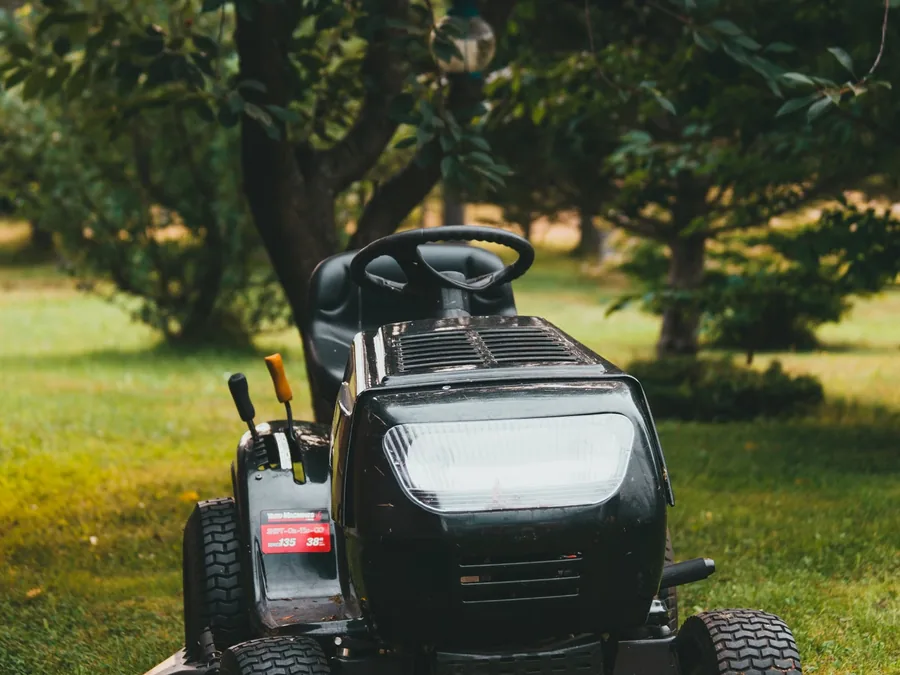 Riding mower maintaining a residential backyard